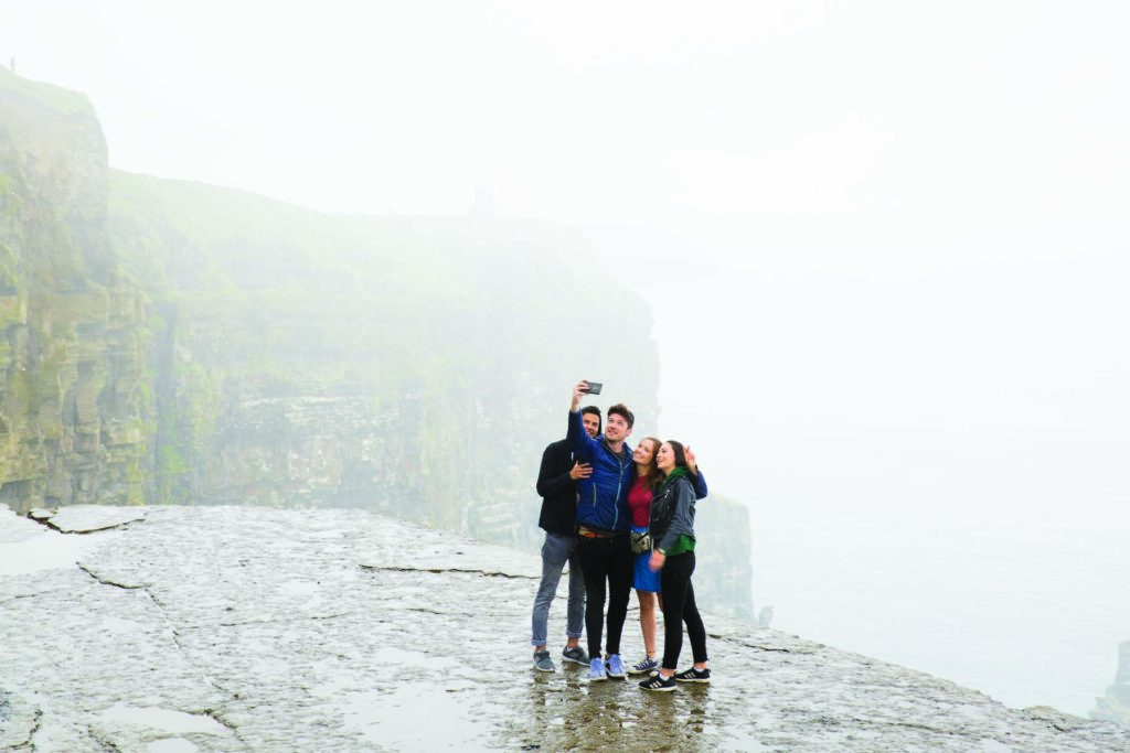 Group selfie on rainy day at the Cliffs of Moher, Co Clare ©James Bowden for Contiki and Tourism Ireland